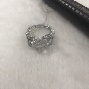 Silver wired ring with clear beads across the top